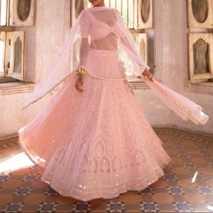 Pink lengha with mirror work on the blouse and embroidery all over